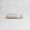 Taupe and ivory stripe hand towel with hand knotted fringe edges. 100% Turkish cotton.