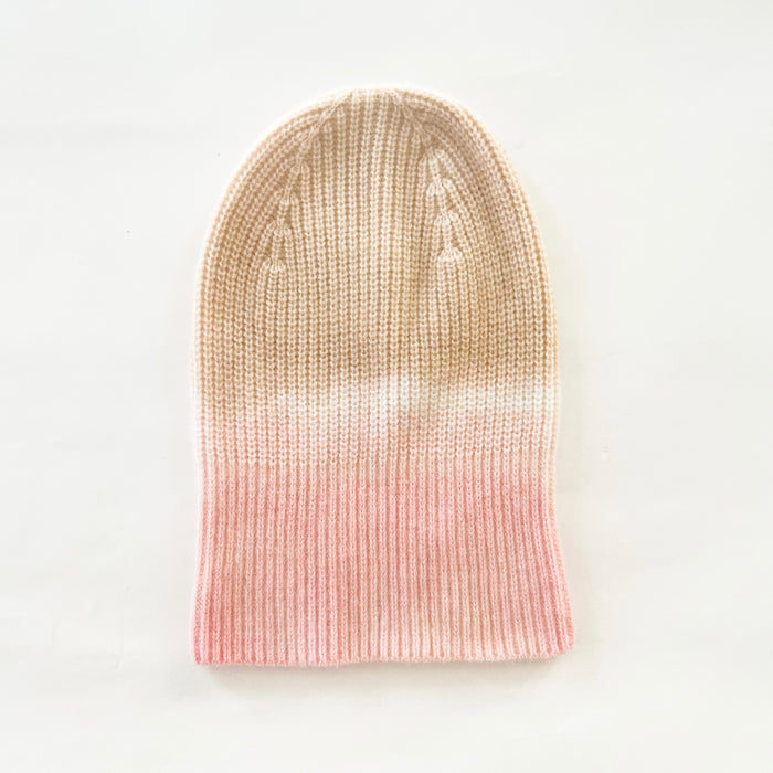 Sunset + Sand dip dyed cashmere beanie. 100% cashmere in a rib stitch hand dyed with a sand crown and blush pink base.