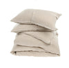 Stack of folded linen duvet and pillow shams. 100% linen in a neutral flax color.  Sold as a set, includes two matching pillow shams. Available in Queen and King size.