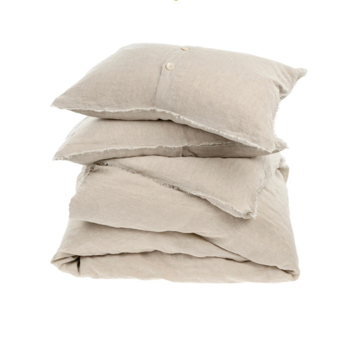 Stack of folded linen duvet and pillow shams. 100% linen in a neutral flax color.  Sold as a set, includes two matching pillow shams. Available in Queen and King size.
