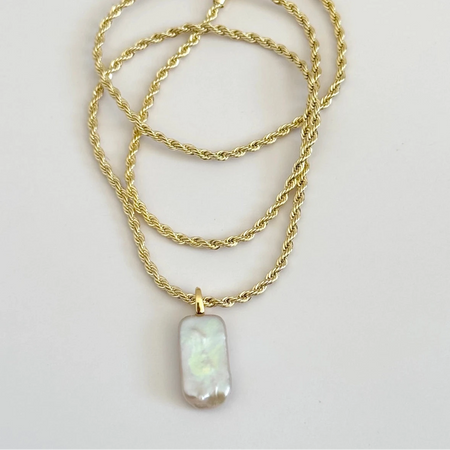 18K gold filled twisted rope chain featuring a long Baroque pearl pendant. 18 inch length with lobster claw clasp.