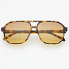 Aviator style sunglasses with tortoise frame and amber tinted lenses on a white background