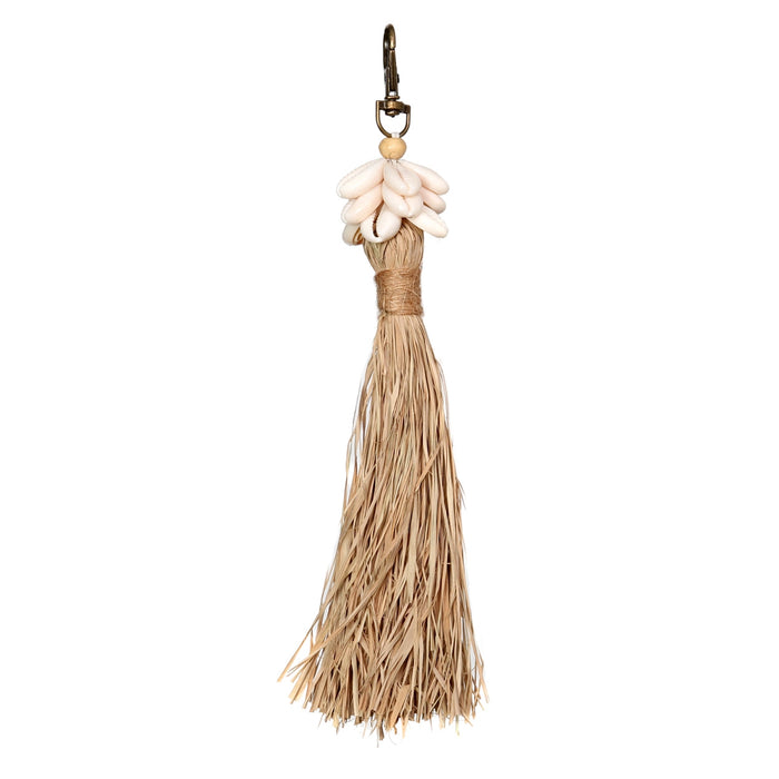 Boho Bag Charm. A raffia tassel crowned with white cowrie shells on an antique finished brass lobster clasp. Perfect for clipping on a bag or using as a key chain. Tassel measures 6.5" length, total length 8".