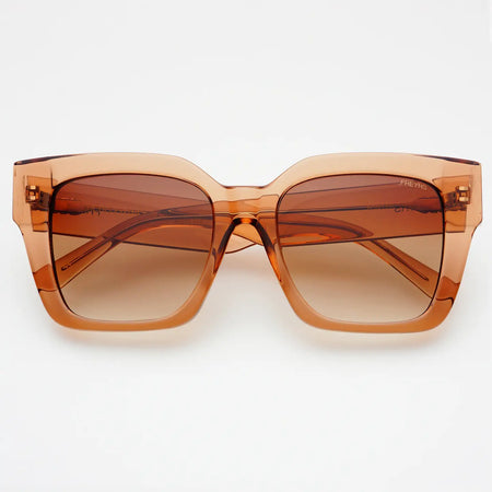 Over sized  sunglasses in a translucent warm brown acetate frame on a white background.
