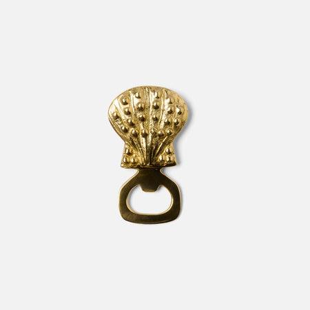 Brass seashell bottle opener. 3.75 inch x 2 inch. Wipe clean with a soft dry cloth. 
