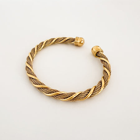 Brenner Cuff. Modern and minimalistic open ended cuff made of twisted gold  mesh with a spiral of gold. Finished with etched open end caps. Water, sweat and tarnish resistant. Made of hypoallergenic stainless steel with 14k gold plating and special coating. 6.75" circumference end to end, 8"total circumference.