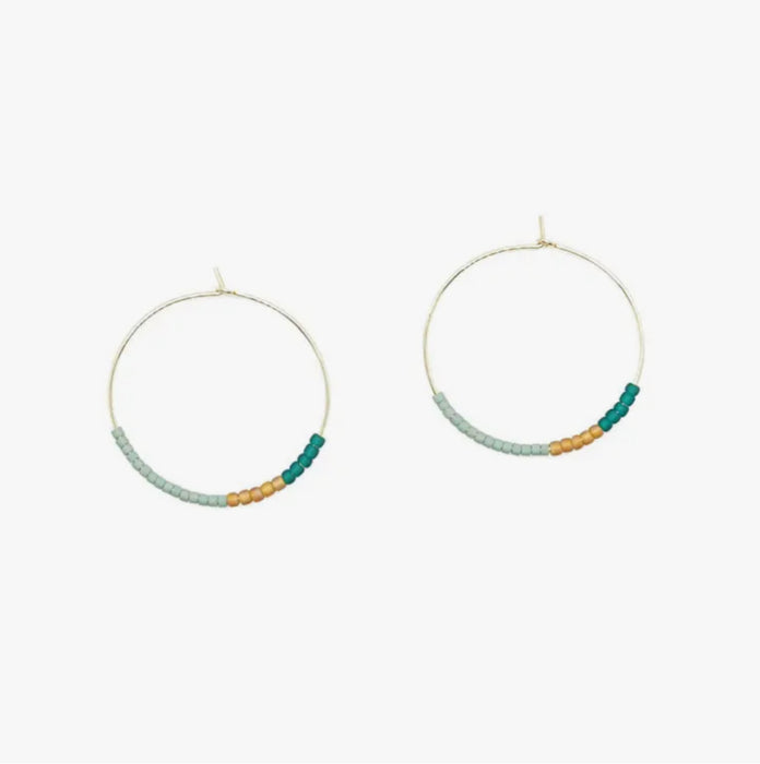Selena hoop earrings. Delicate 14k gold filled wire hoops threaded with tiny Japanese glass beads in shades of aqua and gold. Hoop measures 1.25" diameter.