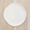 White melamine "Cloud" dinner plate. Part of the Nube collection by Beatrix Ball. Irregular organic shape with a matte white finish. Measures 11" diameter. 