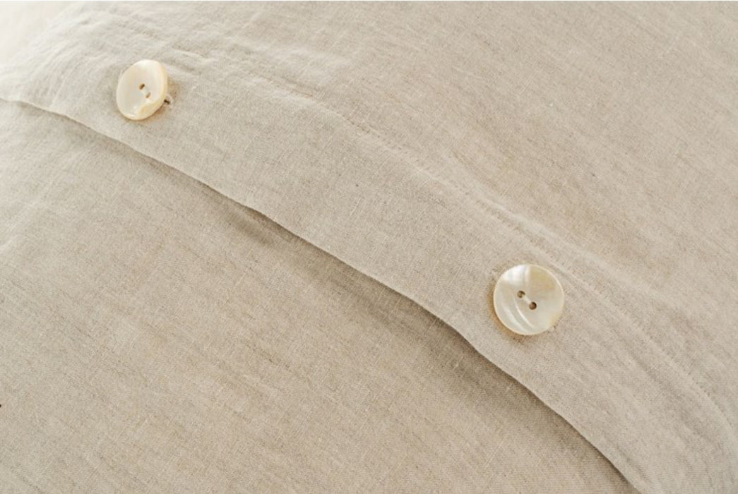 Pearl button through, envelope closure on linen pillow shams. Sold as a set of 2 with matching duvet cover. 100% linen in neutral flax color.