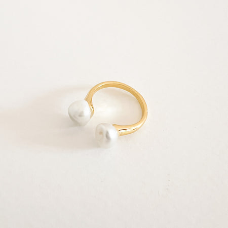 Chloe pearl ring. Modern open ended 14k gold plated ring. Each end finished with a white baroque pearl. Ring diameter approximately .75". Open ended design allows you to adjust the fit by applying gently pressure to the ring.