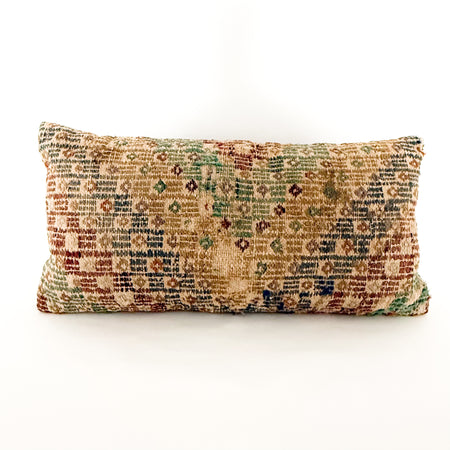 12 x 24 inch lumbar pillow made from a vintage Turkish textile. Geometric pattern woven in sun-faded hues of sage, emerald, blue, lavender tan and sepia. Wear is a sign of the vintage aspect of the textile. Solid mocha brown back with zip closure.