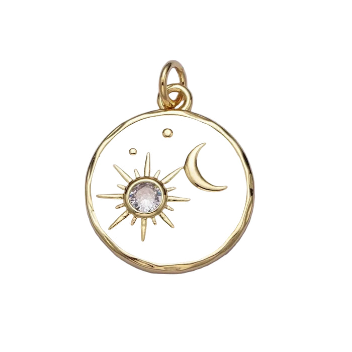 Round gold and white enamel pendant charm with a golden moon and sun with a sparkling CZ stone. 14K gold plated over brass. 