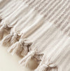 Close-up of the hand knotted fringe border on the Aubrey Towel. 