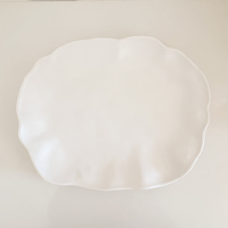 Cloud melamine tray by Beatrix Ball. Matte white shatterproof luxury melamine tray in a sculpted organic silhouette. Measures 15.5" x 12". Perfect for entertaining with style and ease indoors and out.