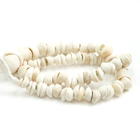 A coiled strand of white shells strung on hand braided cord. 15" length. 