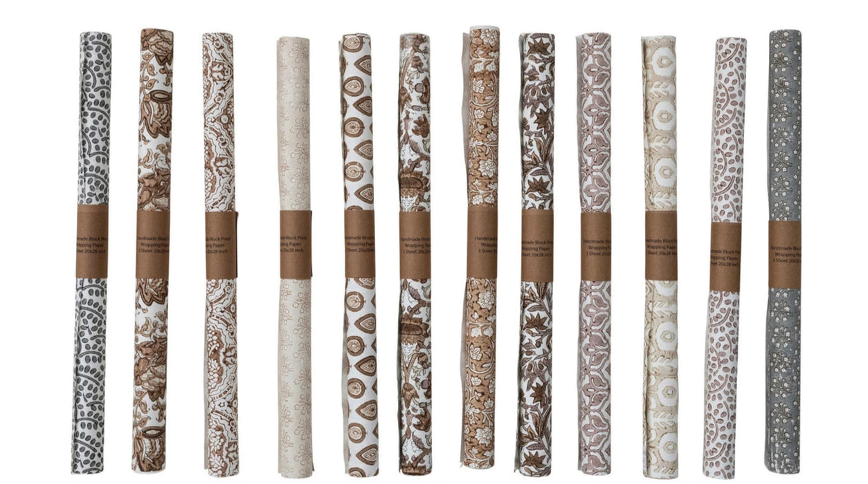 Twelve rolls of block printed gift wrap in soft neutral colors. Each roll is a different print. Roll contains three sheets. 28" x 20"