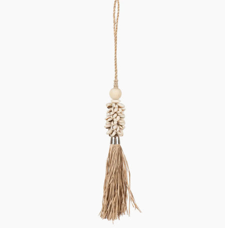 Decorative tassel made of natural raffia, crowned with a bundle of cowrie shells. Strung on a twisted raffia rope with wood bead. Hang on a doorknob, layer over vase or dispay in a tray. Tassel measures 9.5" lenght, 1" total length.