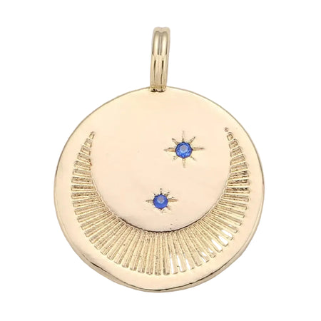 A round gold medallion pendant with a delicate crescent moon etched and  two small blue gemstone stars. 18k gold filled over brass. 24m x18mm