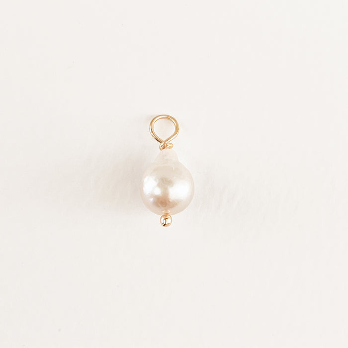Round Baroque pearl charm. White pearl with gold filled fittings. Designed to layer on our charm builder necklaces and earrings. .5" diameter.