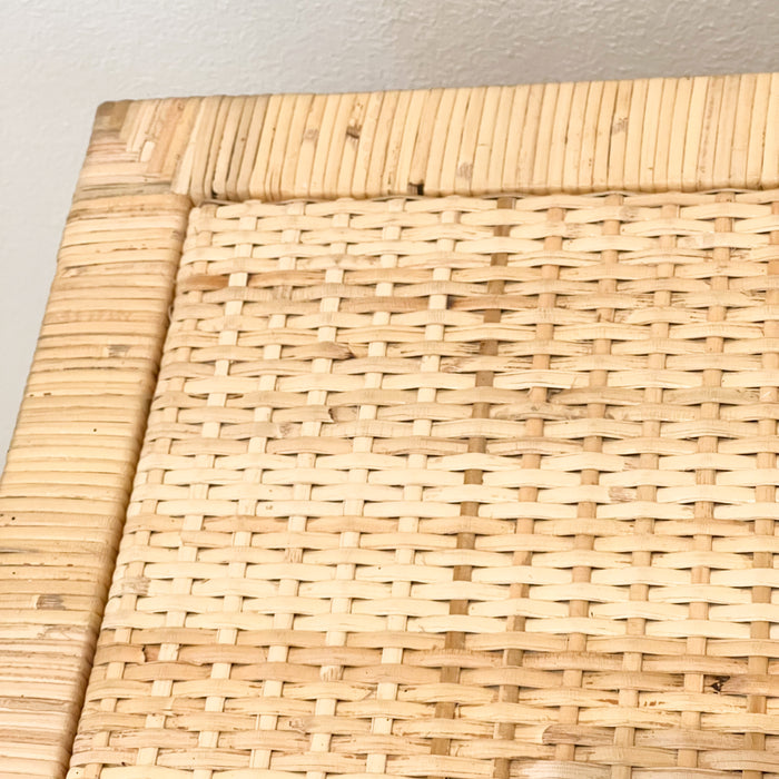 Close up detail of finishing on the Delray chest of drawers/dresser. Solid wood frame hand wrapped in natural rattan with woven rattan panels on sides, top and drawer face.