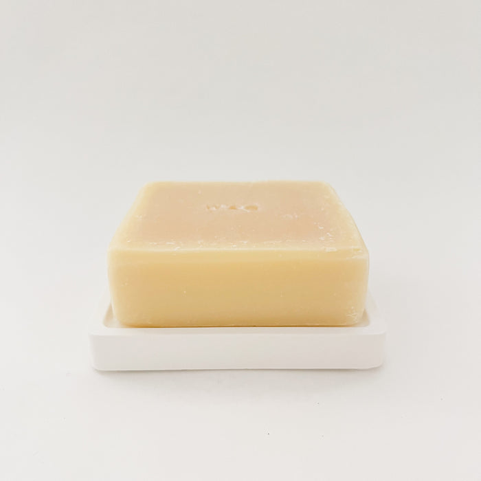 Solid dish soap bar in lemon scent on a white earth stone soap dish. Each sold separately. Eco friendly and sustainable kitchen clean up. Less packaging, less waste. Made in Upstate New York by an artisan soaper.