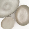 Three oval shaped stoneware bowls in an oyster grey glaze. Each piece sold separately.