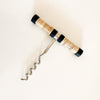 Brisbane corkscrew made of stainless steel with a natural rattan handle and black trim.