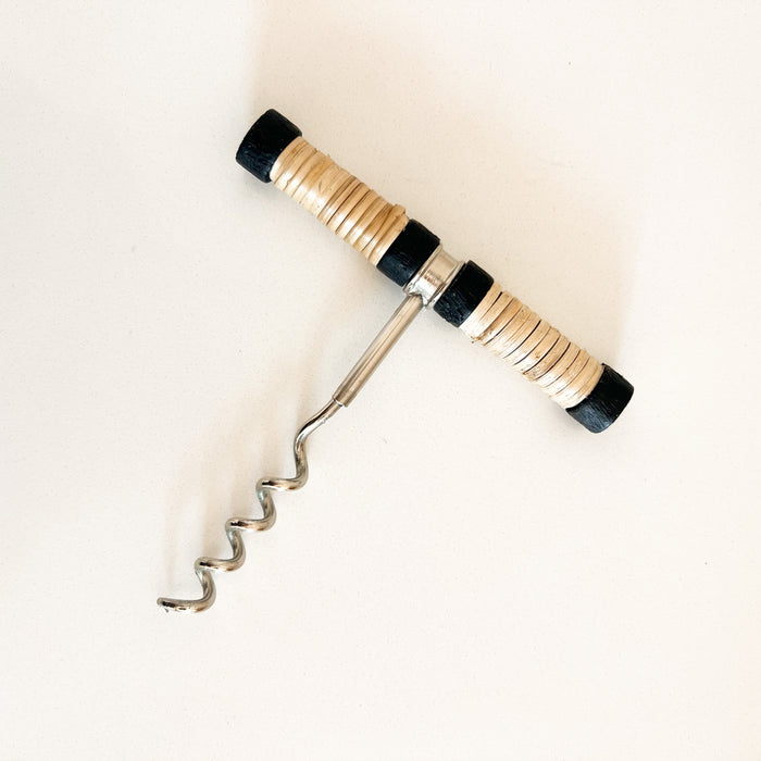 Brisbane corkscrew made of stainless steel with a natural rattan handle and black trim.