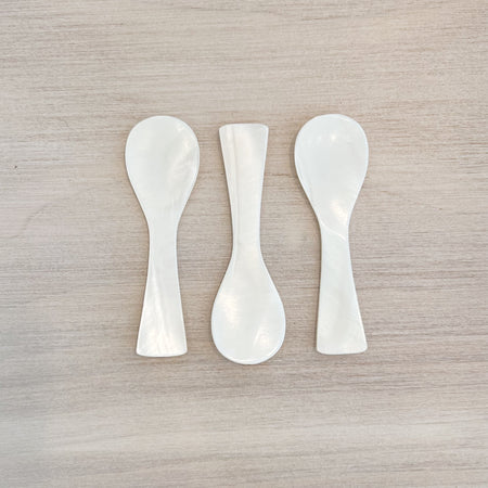 Set of three white shell appetizer spoons. Measures 3" length 1" width. Hand wash only.