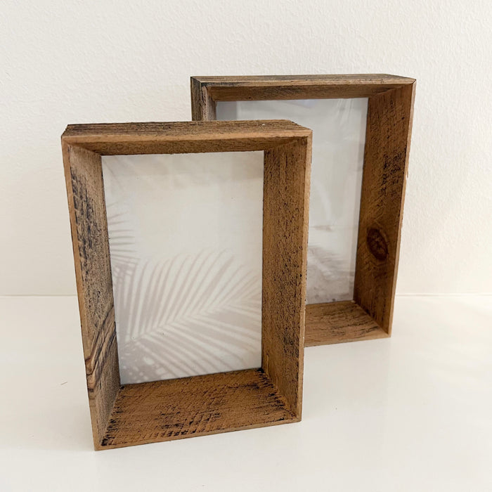 Two salvage raw wood picture frames standing together. 4"x6" and 5" x7". Deep 2" frame stands on its own for tabletop display.