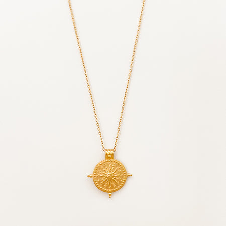 Beckett Sun Disk Necklace by Ellie Vail. Gold sun pendant on delicate chain. Gold plated on marine grade stainless steel. Water, sweat and tarnish resistant. 15" length with 2" extender.