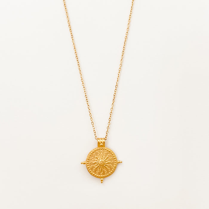 Beckett Sun Disk Necklace by Ellie Vail. Gold sun pendant on delicate chain. Gold plated on marine grade stainless steel. Water, sweat and tarnish resistant. 15" length with 2" extender.