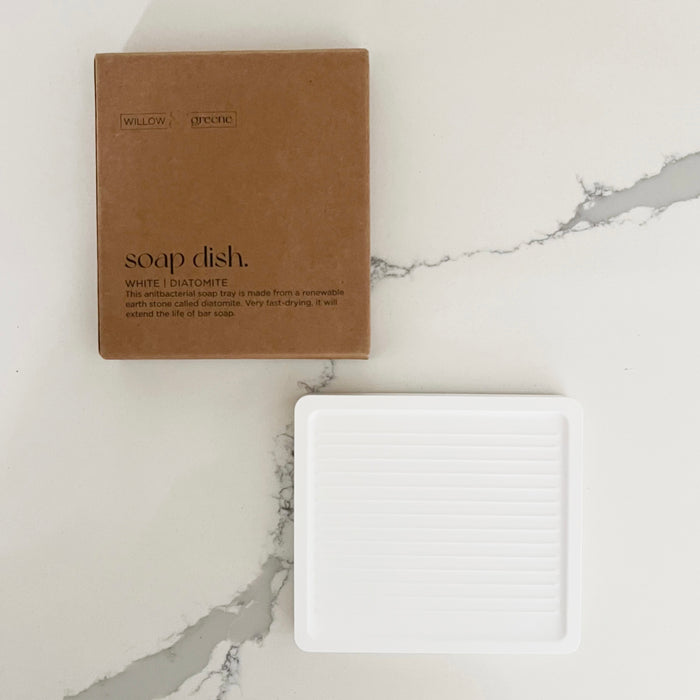 White soap dish made of Diatomite, a natural stone that is antibacterial and mildew resistant. Packaged in a recyclable Kraft box. Designed to hold our solid dish soap bars. 3.4 x 3.7 inches.