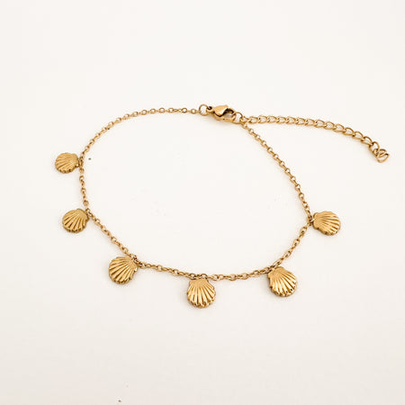 Endless Summer Anklet by Ellie Vail. A delicate gold chain anklet with 6 dainty gold seashell charms. Measures 7.5" with a 2" extender. Water, sweat and tarnish resistant. Made of hypoallergenic marine grade stainless steel with gold plating. 