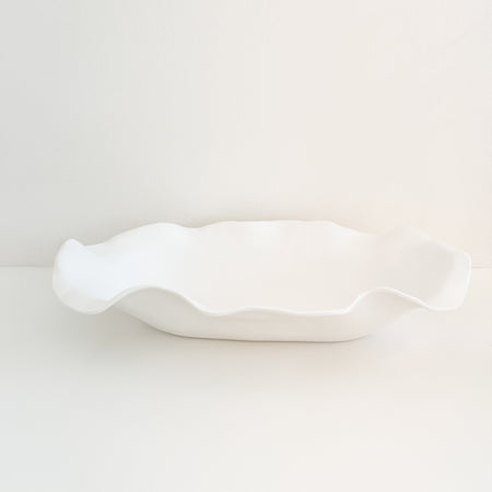 Cloud melamine serving platter. Large oblong platter or centerpiece in a sculptural organic shape. Measures 24.5" x 15" x 4" depth. Made of shatterproof melamine with a matte white finish. Made for everyday use, entertain with style and ease indoors and out with melamine. BPA free. Dishwasher safe on top rack.