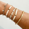 Bracelet stack featuring 14k gold filled bamboo cuff and neutral stretch Isla bracelets. Each sold seperatley.