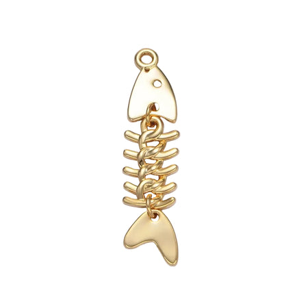 Minimalist gold fish bone charm on white background. 