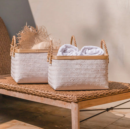 White rectangular bamboo storage baskets with natural bamboo edge and rope handles. Medium  15" length 11" width 9" high. Large is 18.5" length 13" width 10" high. Each sold separately.