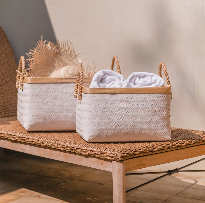 White rectangular bamboo storage baskets with natural bamboo edge and rope handles. Medium  15" length 11" width 9" high. Large is 18.5" length 13" width 10" high. Each sold separately.