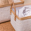 White bamboo storage baskets handwoven in a herringbone weave. Rectangular shape with natural bamboo edge and rope handles.