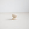 Gem ceramic candle holder, part of the Pebbles collection designed to hold the slim Wish Candles (sold separately). Soft organic form inspired by beach pebbles formed in ceramic with a matte white glaze. 2" diameter x 1.25"tall. 