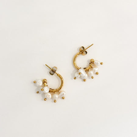 Gia Hoops. Delicate open ended gold plated hoop earrings with five delicate fresh water pearl charms. Water, sweat and tarnish resistant.