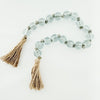 34 inch decorative blue glass bead garland with natural jute tassels on each end. Glass beads measure 1".
