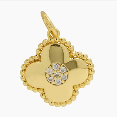 Gold clover flower shaped charm with a center of clear CZ stones.