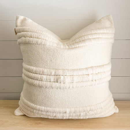 Hamstead Pillow. Luxury textured ivory pillow made of soft New Zealand wool with thick channels of lofty wool yarns creating a stripe pattern. Back is solid cream. 26" square pillow with down insert.