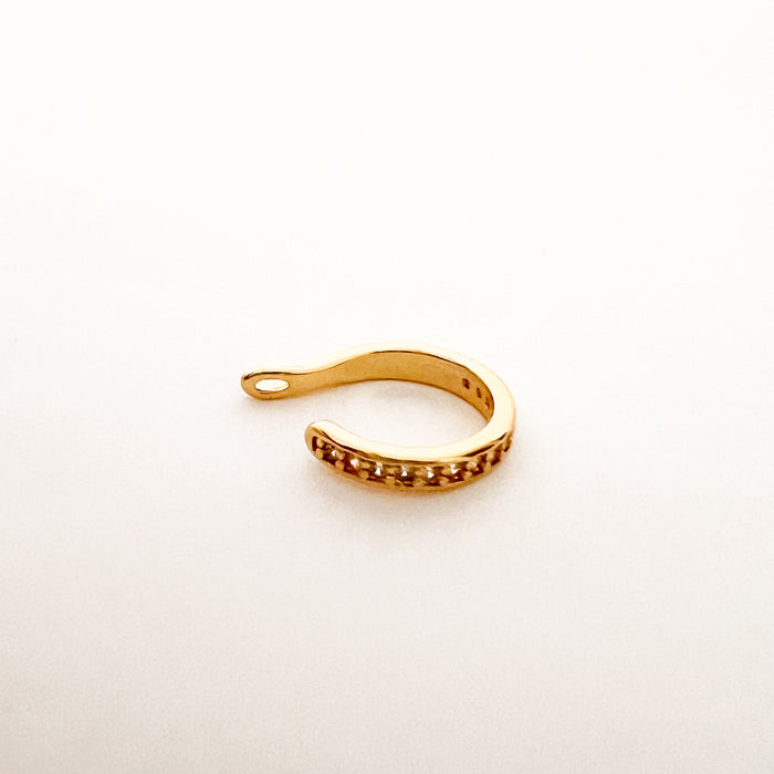 Hayden Ear Cuff. A single gold plated ear cuff with sparkling clear CZ stones. Does not require a piercing, gently hugs the ear lobe. Made of gold plated hypoallergenic stainless steel with protective coating. Water, sweat and tarnish resistant. 1/8 inch thick.