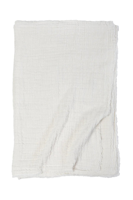 Hermosa gauze throw in cream. Soft double faced gauze throw in an airy cotton linen blend with gently frayed edges. Perfect for a beach house. Measures 60 x 90 inches.