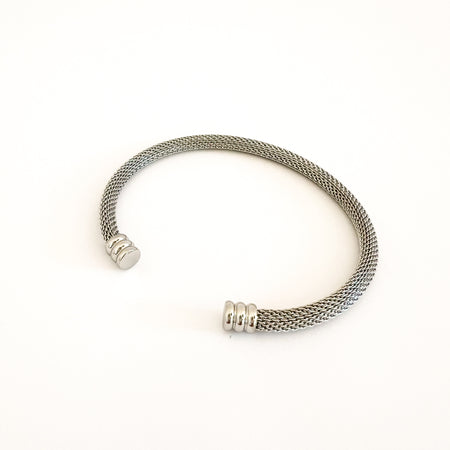 Silver Sinclaire mesh cuff bracelet by Ellie Vail. Open ended silver mesh cuff with ridged end caps. 8" circumference. Sweat, watr and tarnish resistant. Made of marine grade stainless stell with silver plating.