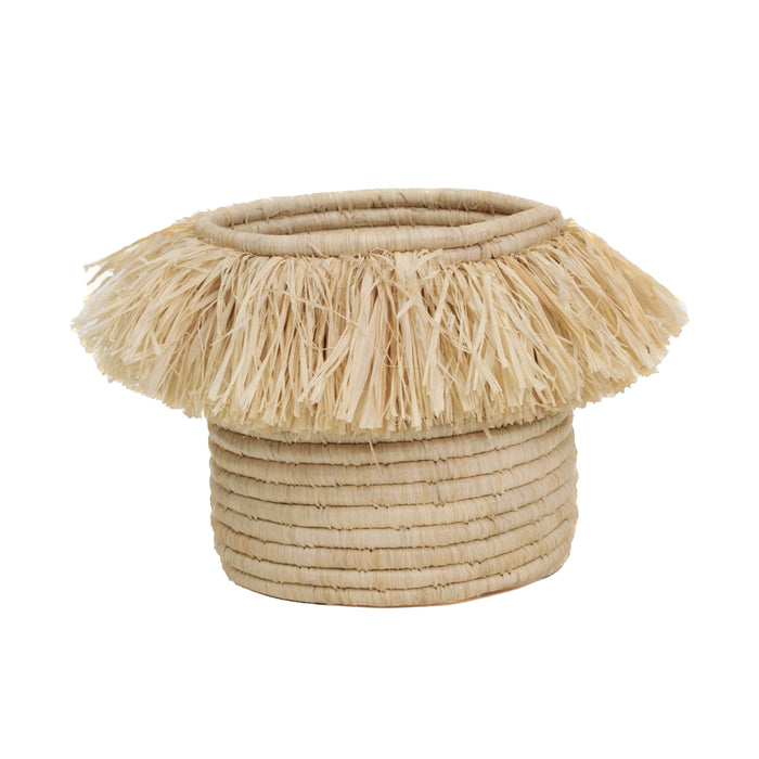 Aurelia basket handwoven in natural seagrass with raffia fringe edge. Round cylinder shape measures 8" high, 8" diameter.