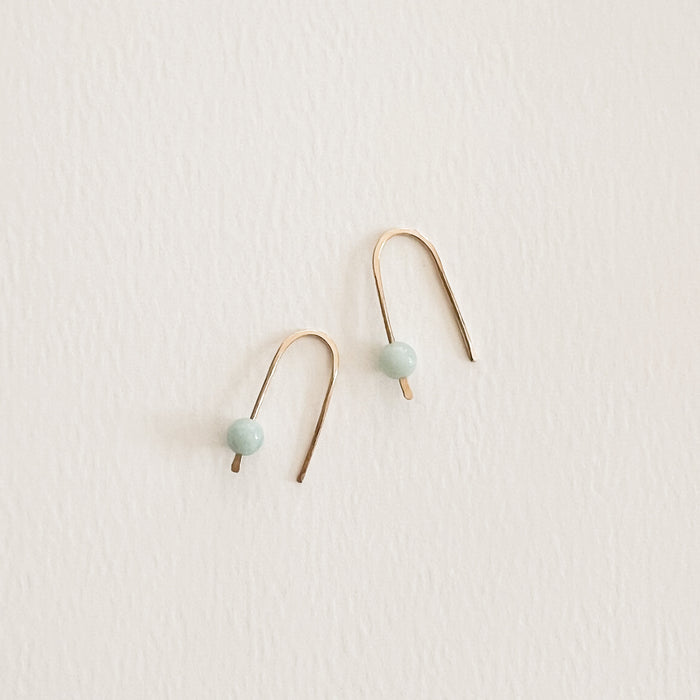 Aqui Arch Earrings. Gold filled wire arches with a delicate pale aqua Amazonite stone. Measures 1". Hand crafted in the U.S.A.